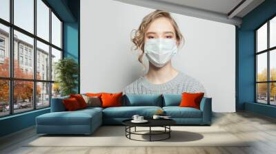 Woman in medical face mask on white background. Woman in medical mack. Flu epidemic and virus protection concept Wall mural