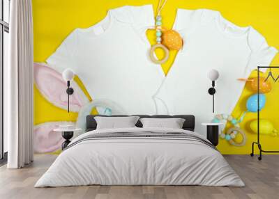 easter springtime baby apparel flatlay on bright yellow table with colorful accessories. twins two b Wall mural