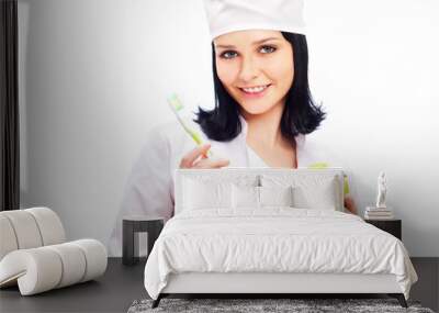 beautiful young female dentist doctor with a toothbrush and gree Wall mural