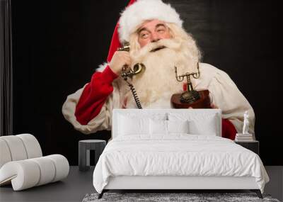 Portrait of happy Santa Claus calling phone Wall mural