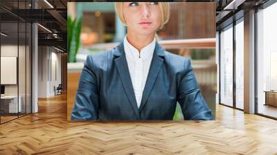 portrait of pretty young businesswoman sitting relaxed and looki Wall mural