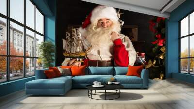 santa claus at home playing with new toys near christmas tree Wall mural