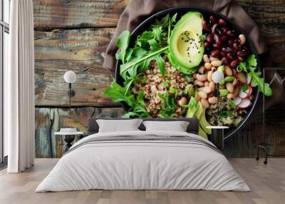 Photo, a healthy vegan bowl featuring black-eyed peas, quinoa, avocado, and mixed greens, beautifully arranged, high-angle composition, natural daylight, rustic wooden table background Wall mural