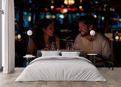 A couple enjoys a romantic dinner date at a cozy restaurant, surrounded by dim lighting and elegantly set tables, showcasing a warm and intimate atmosphere. Wall mural