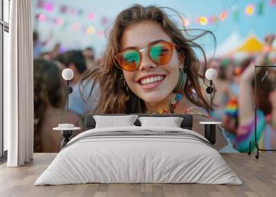 A girl wearing stylish sunglasses and vibrant attire enjoys a colorful outdoor festival, reflecting the joy and exuberance of festive celebrations under bright skies. Wall mural