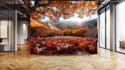 A vivid autumn landscape showing colorful trees with orange and yellow leaves, mountains in the background, and the sun rising, casting a beautiful golden light over the scene. Wall mural