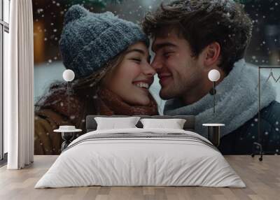 A young couple with cozy winter clothes snuggled together amidst swirling snowflakes, expressing warmth and closeness in the frosty air of winter. Wall mural