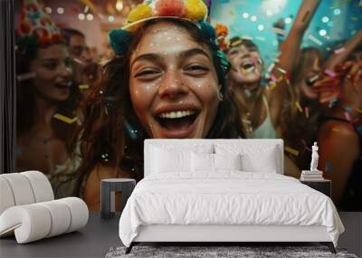 A young woman smiling joyfully with colorful confetti and friends at a lively celebration, creating a vibrant and cheerful party atmosphere with glitter on her face. Wall mural