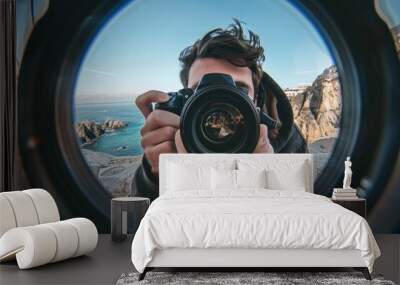 The enthusiastic photographer, while taking photos, is depicted through the fish eye lens, his camera work highlighted in a close-up that shows his passion for every detail Wall mural