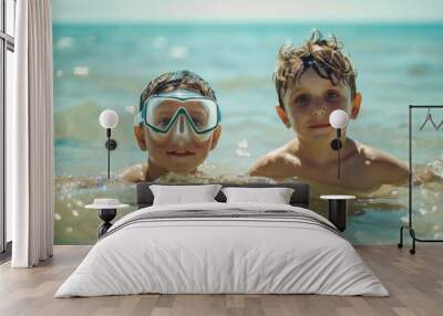 Two children are happily swimming in the sea, where one is wearing goggles, and both are immersed in the fun and joy of their beach adventure on this luminous day. Wall mural