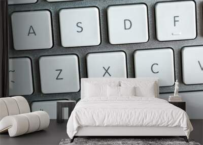 Close up of white wireless aluminum keyboard Wall mural