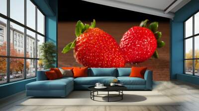 Strawberries, details of two strawberries on the table, black background, selective focus. Wall mural