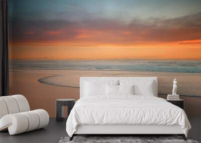 beautiful sunset on beach with a wave on the shore Wall mural