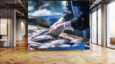 fishmonger picking fish in fish market Wall mural