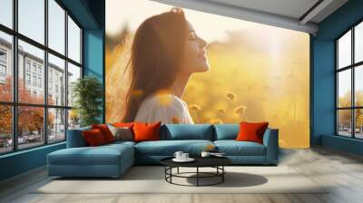 young woman in a field of yellow flowers Wall mural