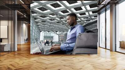 african american businessman sitting at station with laptop Wall mural