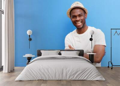 african american man smiling against blue background Wall mural