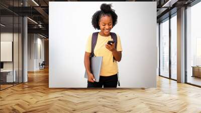 african american teenage girl with laptop and mobile phone against white background Wall mural