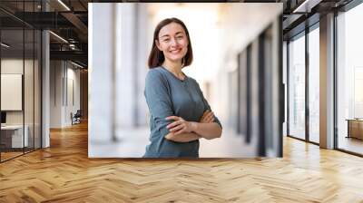 attractive older woman smiling with arms crossed Wall mural