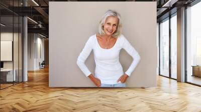 beautiful older woman standing and smiling Wall mural