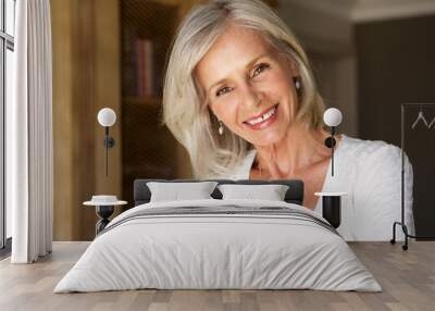 beautiful older woman standing in study smiling Wall mural