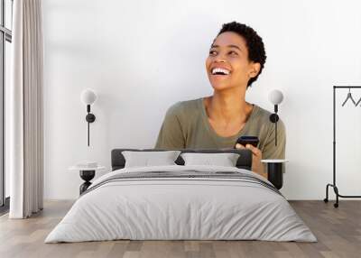 beautiful young black woman laughing with cellphone Wall mural