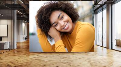 Close up beautiful young african american woman smiling with curly hair Wall mural