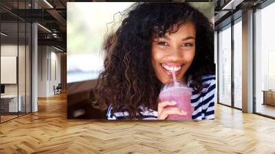 Close up beautiful young woman drinking smoothie Wall mural