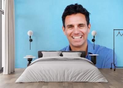 Close up businessman laughing against blue background Wall mural