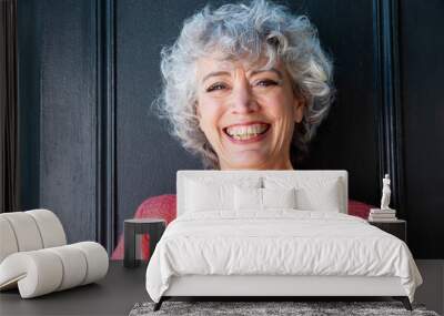 Close up front of happy middle aged woman with gray curly hair Wall mural