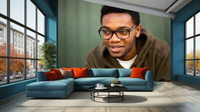 Close up handsome young african american man with glasses looking away Wall mural