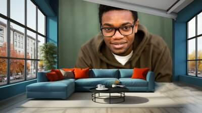 Close up handsome young african american man with glasses staring Wall mural