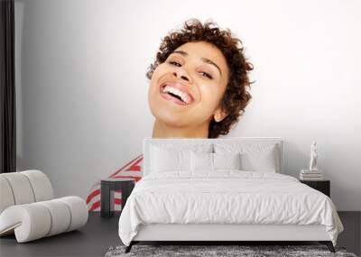 Close up happy african american woman laughing by white background Wall mural