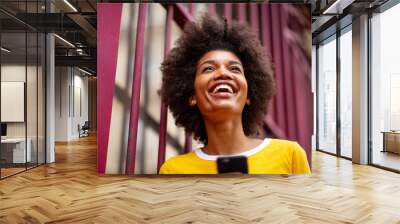 Close up of beautiful young african american woman smiling outside Wall mural