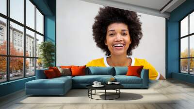 Close up of beautiful young black afro woman smiling by white background Wall mural