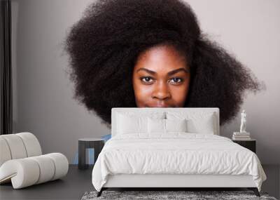 Close up portrait of beautiful young black woman with afro hair staring Wall mural