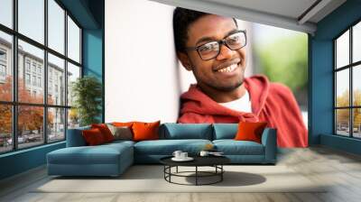 Close up portrait of smiling young african american man with eyeglasses Wall mural