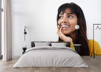 Close up smiling young Indian woman with hand by mouth Wall mural