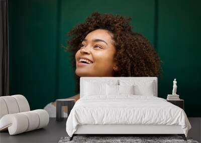 Close up young african american woman smiling and looking up Wall mural