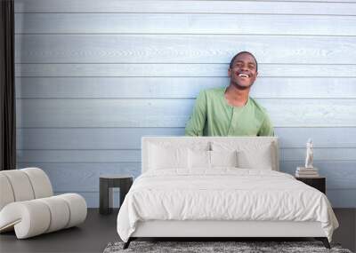 confident guy smiling against gray background Wall mural