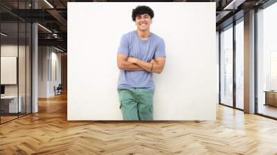 cool guy smiling against white wall with arms crossed Wall mural