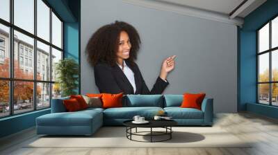 Friendly business woman pointing finger Wall mural