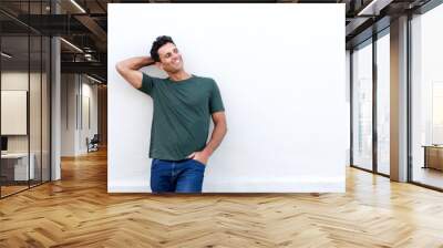 handsome middle age man smiling with hand in hair Wall mural