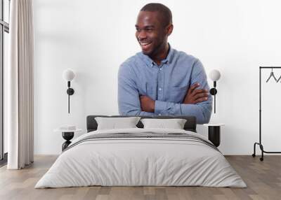 handsome young african american man smiling with arms crossed by white background Wall mural