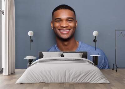 Handsome young black man smiling Wall mural