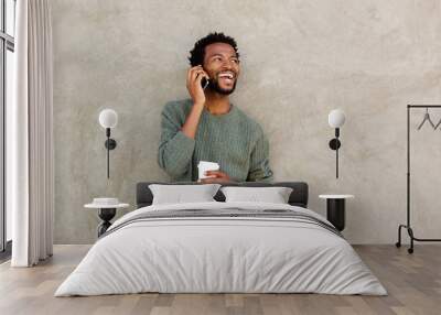 happy african american man talking on smart phone with coffee Wall mural