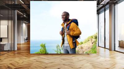 happy african american man with backpack outdoors Wall mural