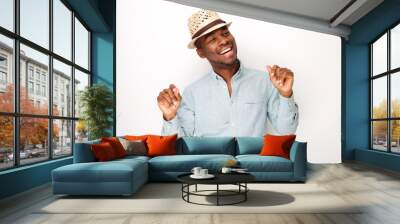 happy african american man with hat dancing against isolated white background Wall mural