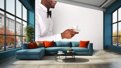 happy african american server holding cup of coffee by white wall Wall mural