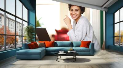 happy african american woman with laptop computer at home Wall mural